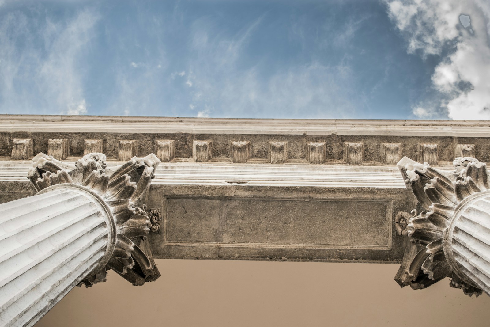 worm eye view of white concrete pillar during day time